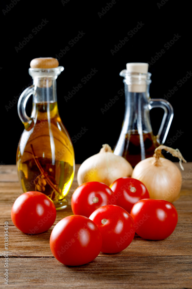tomatoes and bottles of olive oil on rustic table tomatoes and bottles of olive oil on rustic table