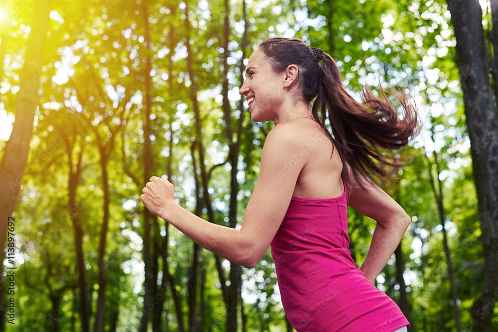 Fit girl jogging in the park on sunny day Fit girl jogging in the park on sunny day