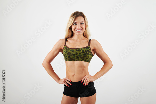  Fit blonde with well trained body in sport khaki top