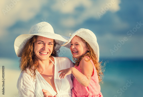 Portrait of happy mother and little daughter on sunny beach © sborisov