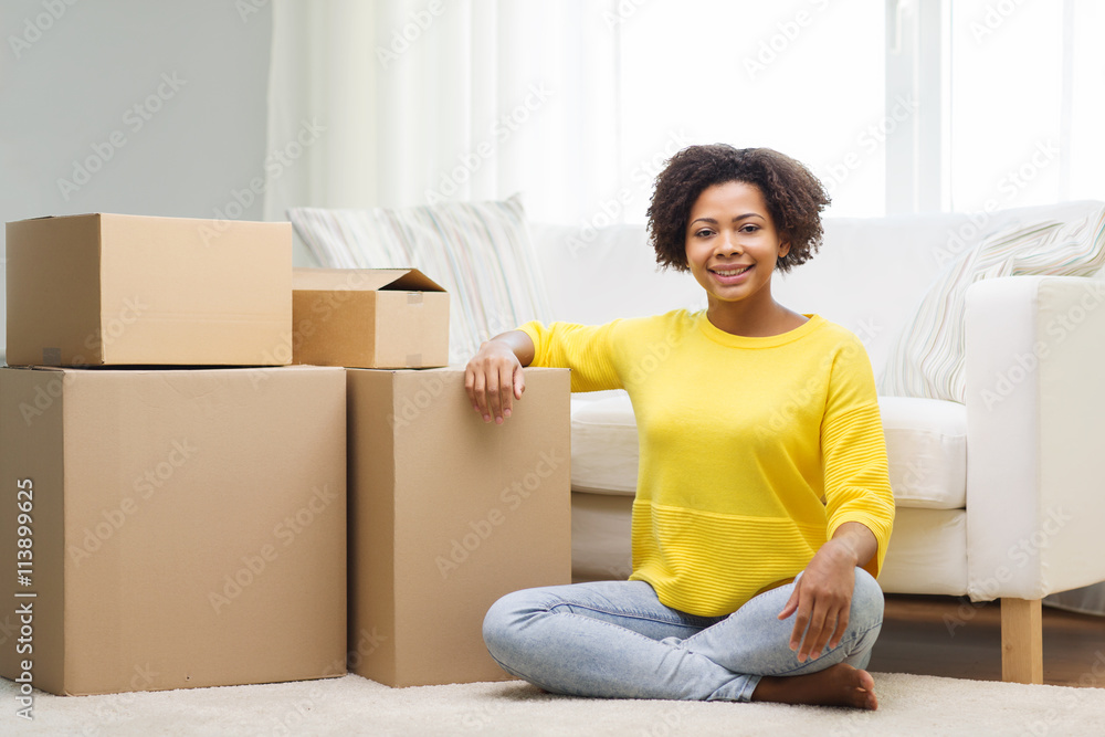 happy african woman with cardboard boxes at home happy african woman with cardboard boxes at home