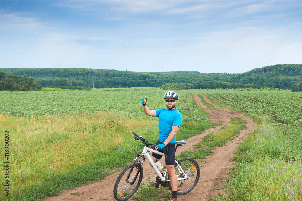 Cyclist on a white bicycle in a blue uniform rides