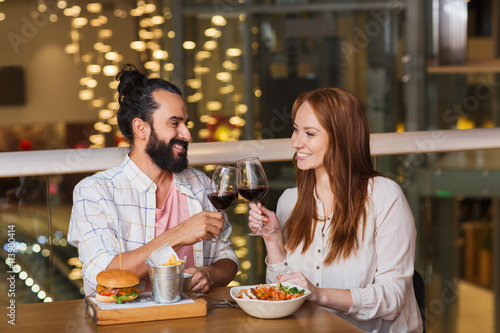 couple dining and drinking wine at restaurant