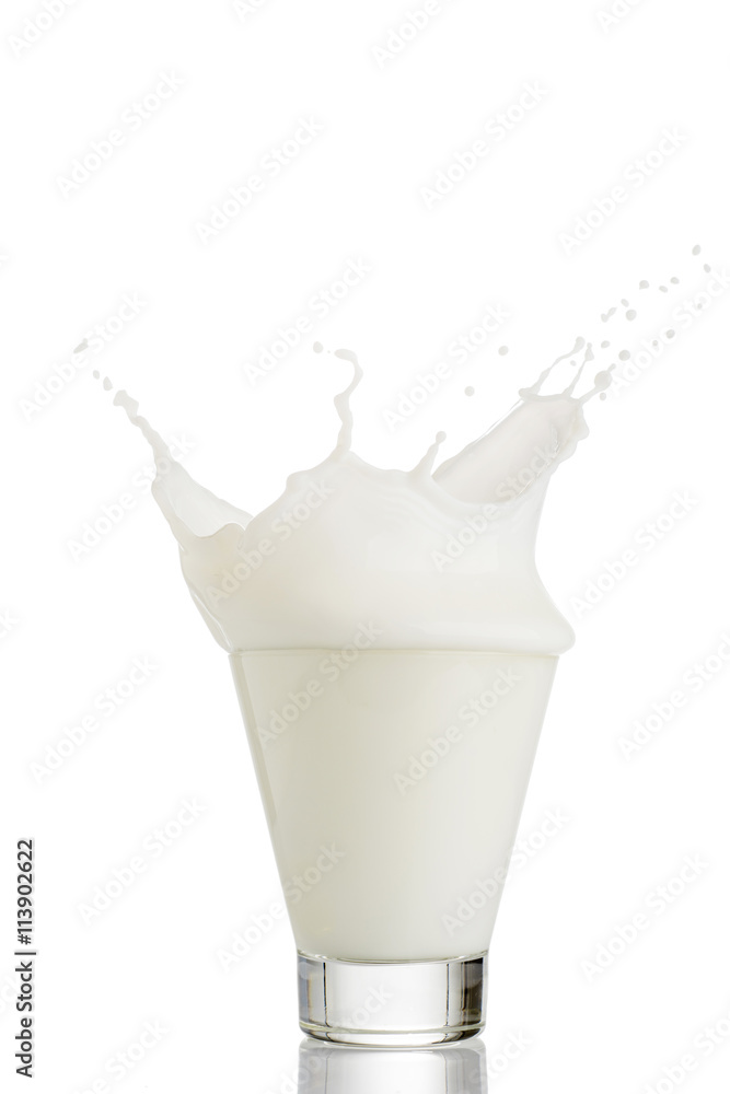 milk splash in glass isolated on white background milk splash in glass isolated on white background