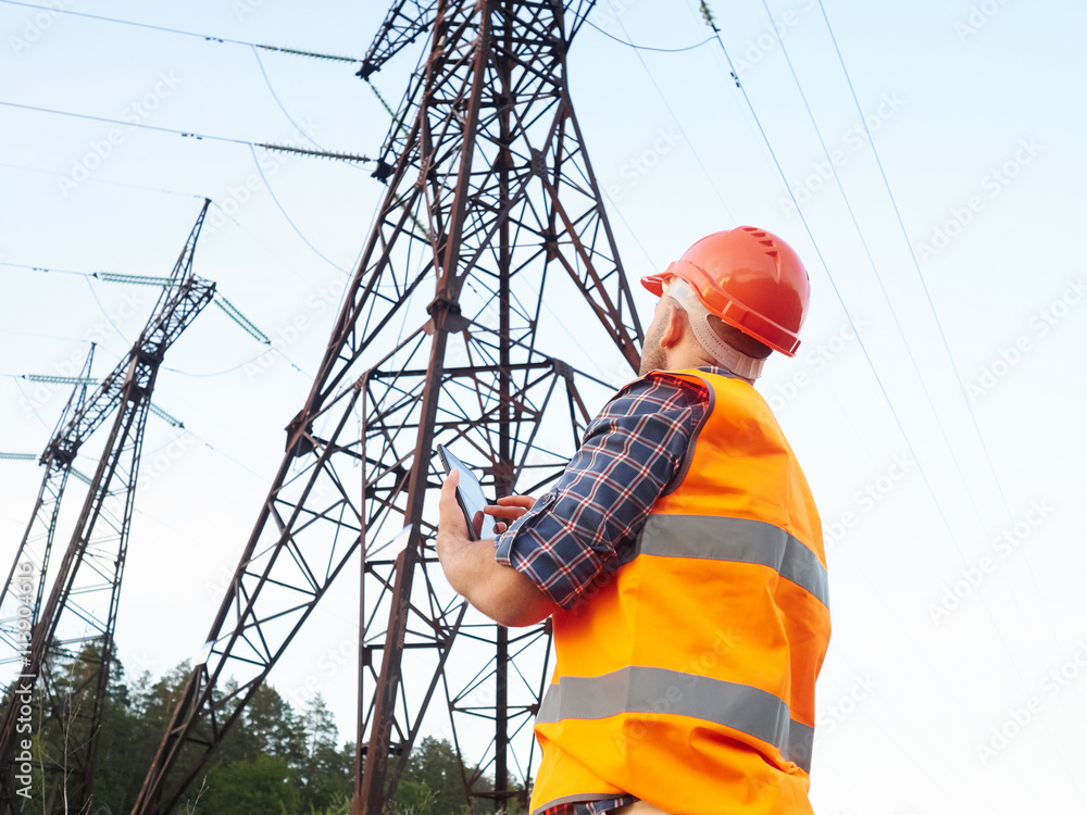 Electrical engineer working. Talking on the phone and working on Electrical engineer working. Talking on the phone and working on