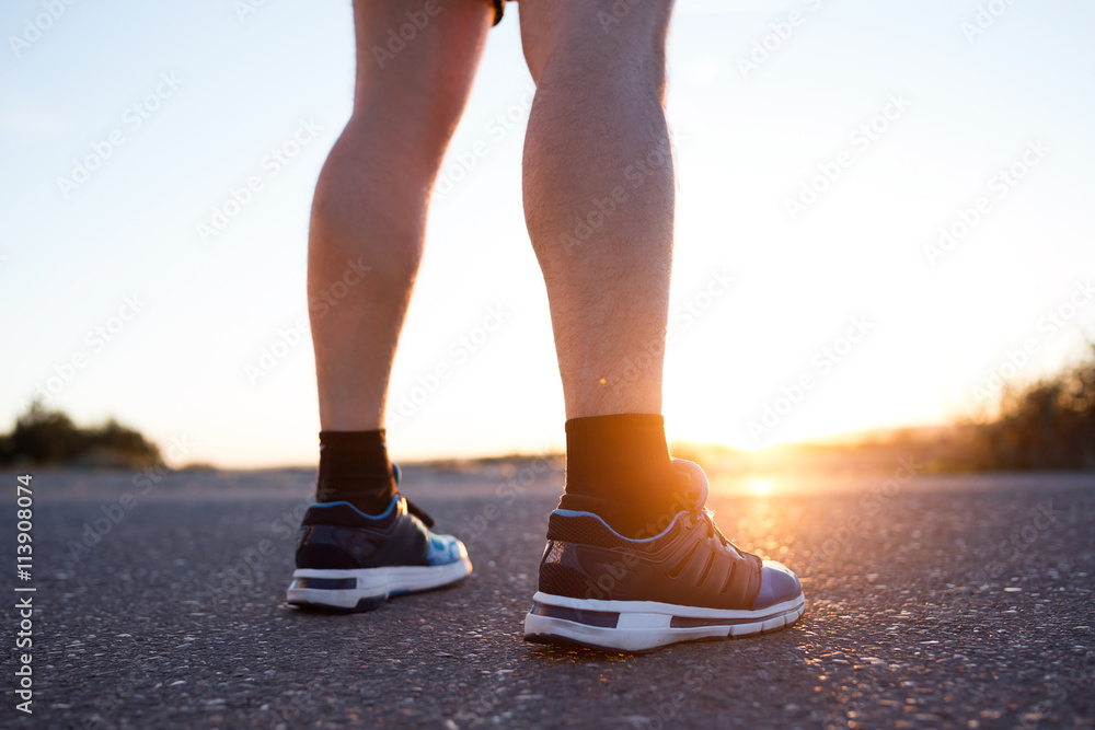 Young man resting after running in the street. Young man resting after running in the street.