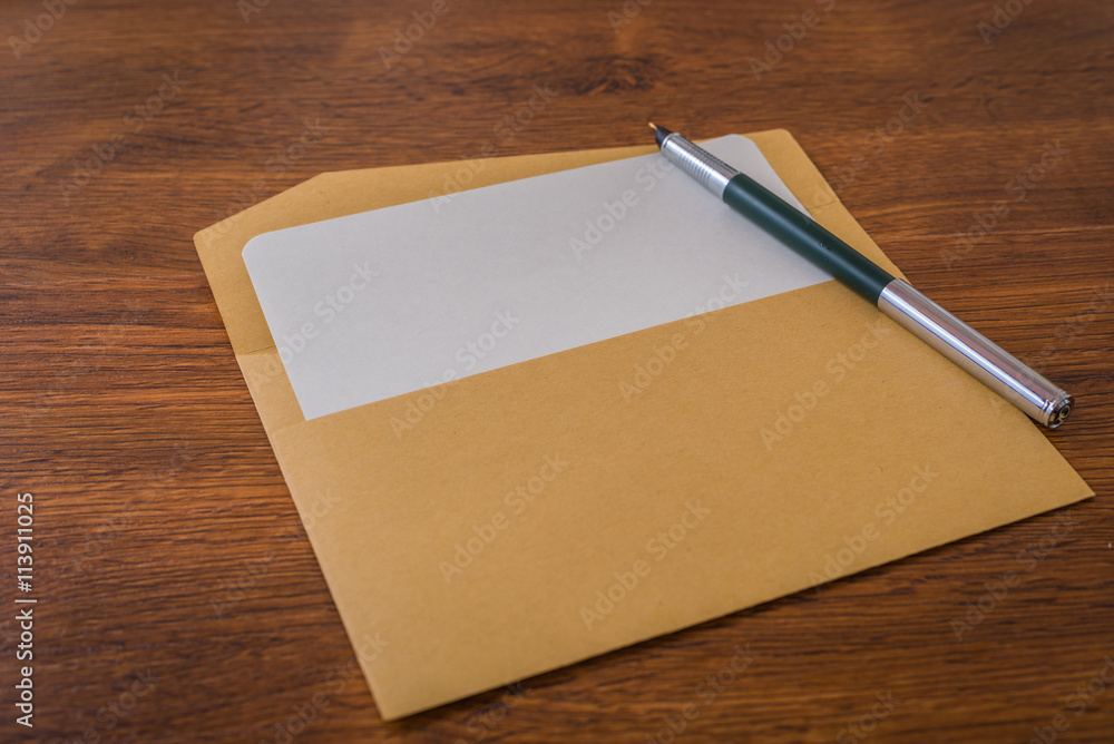 Envelope with pen and white paper Envelope with pen and white paper