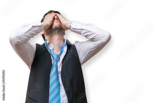 Displeased and disappointed businessman is covering his face. Isolated on white background.