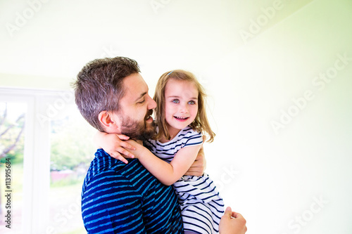 Close up of hipster father holding his little daughter