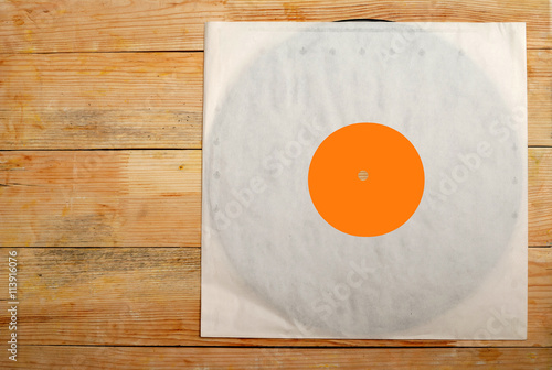 Fotografija Retro styled image of a collection of old vinyl record lp's with sleeves on a wooden background