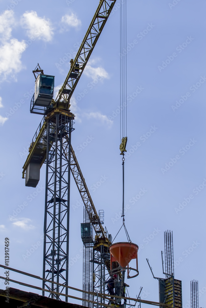 Construction site. Part of tower crane against blue sky. Construction site. Part of tower crane against blue sky.