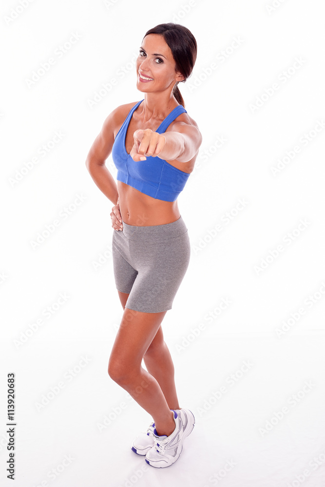 Happy smiling brunette pointing at camera