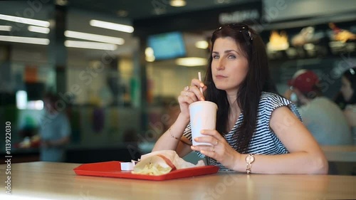 Young women eating fast food and drinkink milk cocktail photo