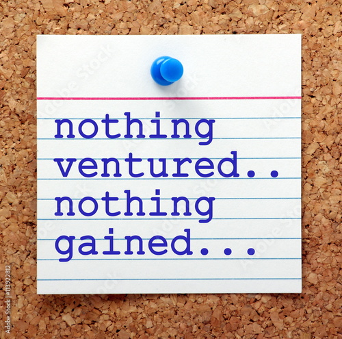 The phrase Nothing Ventured Nothing Gained on a note card pinned to a cork notice board as a reminder