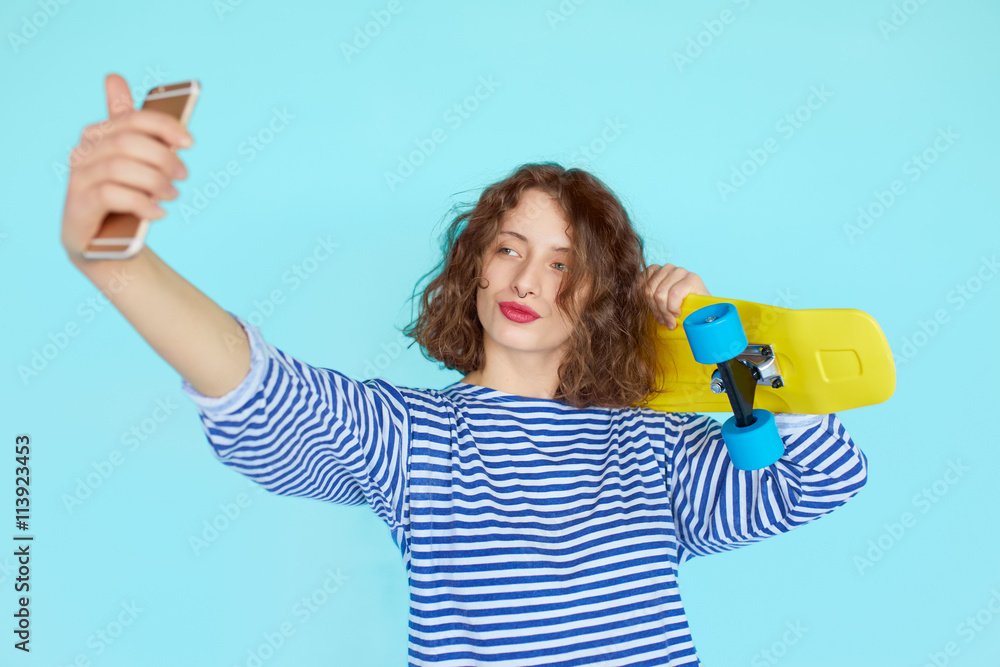 teenage girl in hipster outfit make selfie on a phone teenage girl in hipster outfit make selfie on a phone