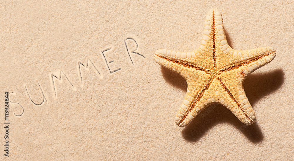 Starfish on sand and summer lettering drawn on sand Starfish on sand and summer lettering drawn on sand