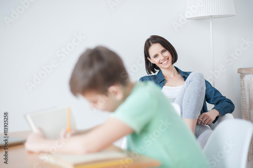 Young teenage boy studying at desk © Yakobchuk Olena