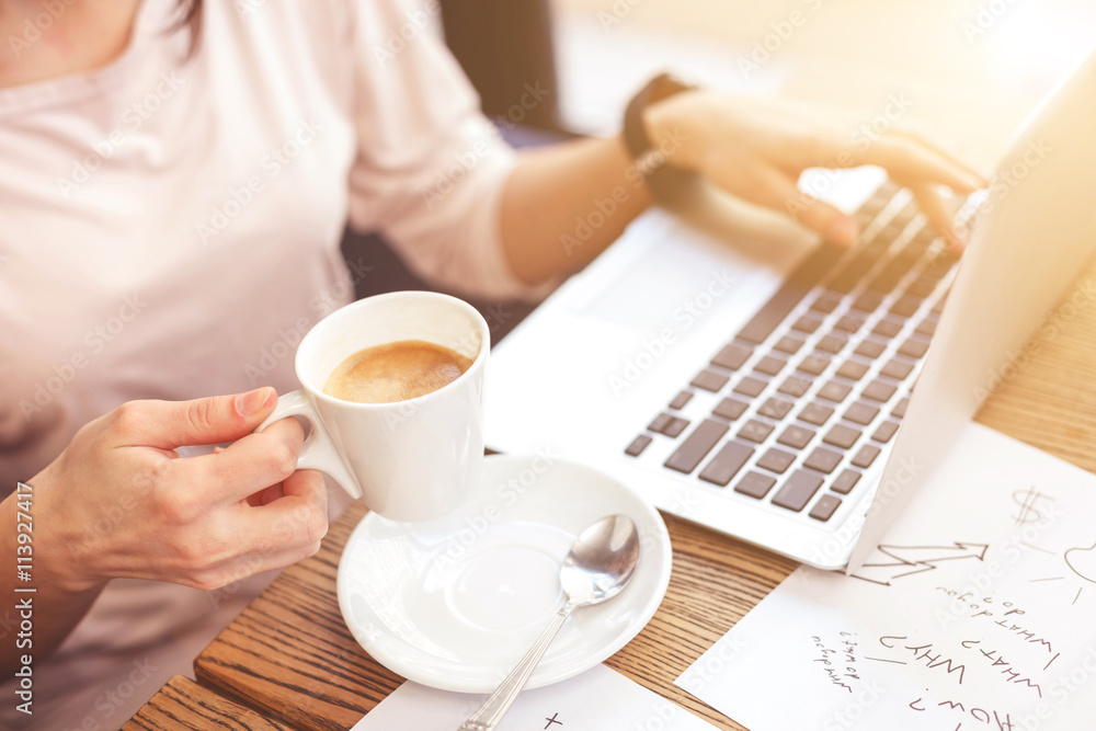 Smart businesswoman making break with hot beverage Smart businesswoman making break with hot beverage