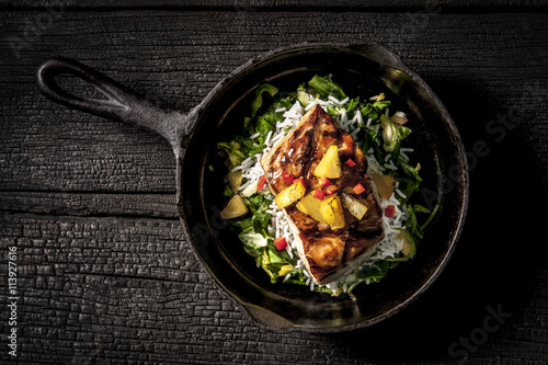 Grouper fish and rice in frying pan