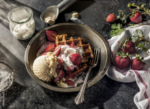 Waffles with strawberries and ice cream in dish