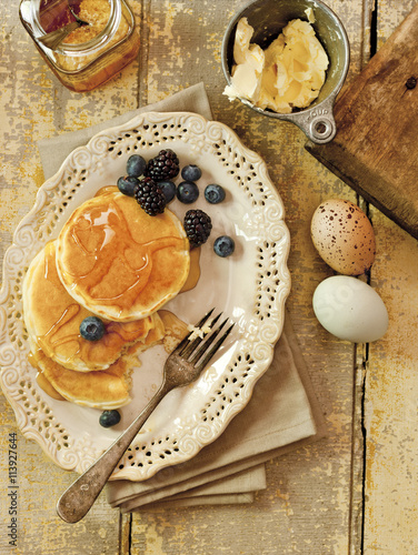 Aerial view of a plate of pancakes and fruit berries