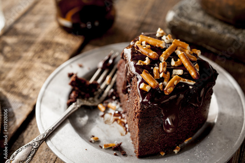 Large portion of chocolate cake on a plate with a fork