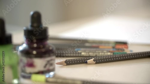 Wallpaper Mural Pencils and bottles with ink for drawing on the table slide camera stock footage Torontodigital.ca