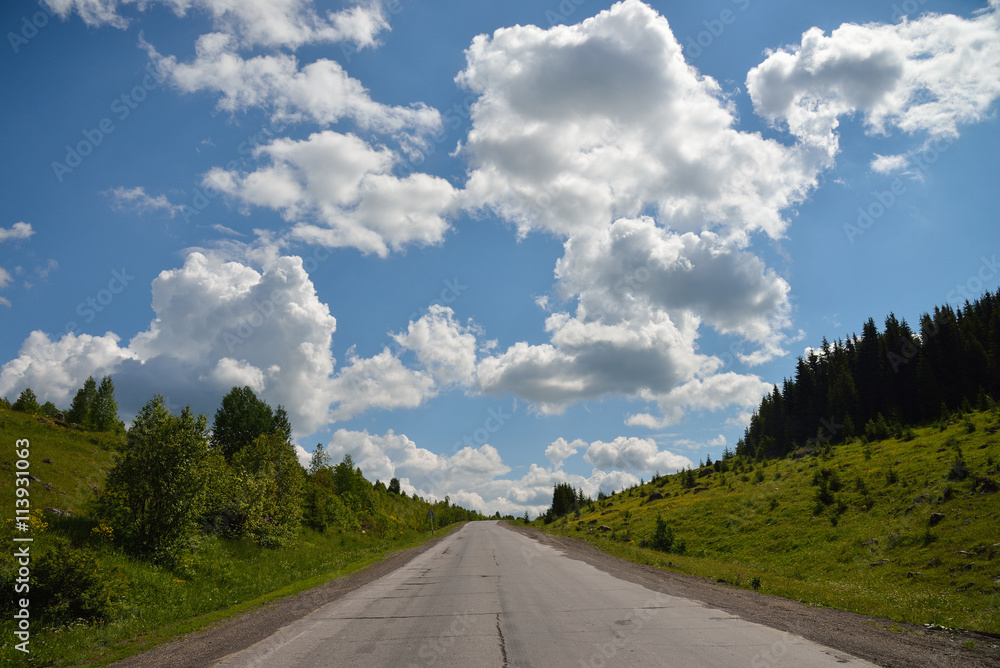 Fototapeta premium scenic view to the road in mountains with beautiful sky