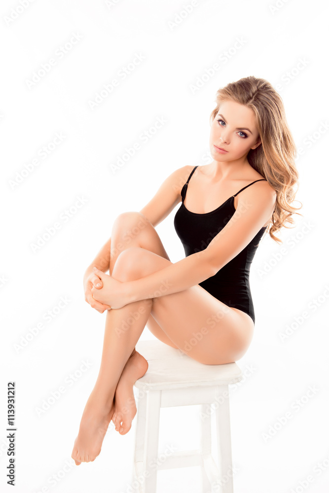 Beautiful sensual woman wearing swimsuit sitting on chair