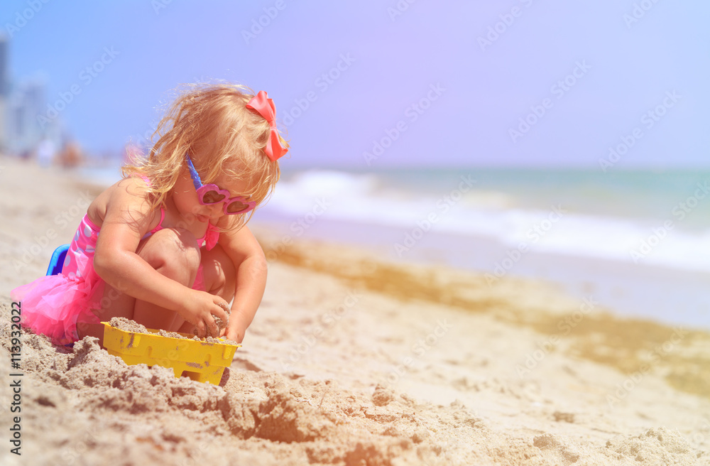cute little girl play with sand on beach cute little girl play with sand on beach