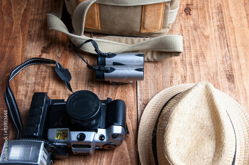 Tourism concept. Backpack, hat , binocular and old camera isolat