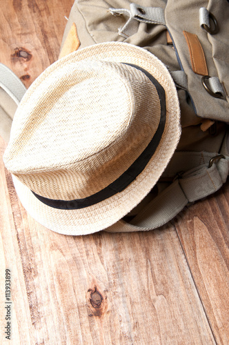 Tourism concept. Backpack, hat isolated on wooden background