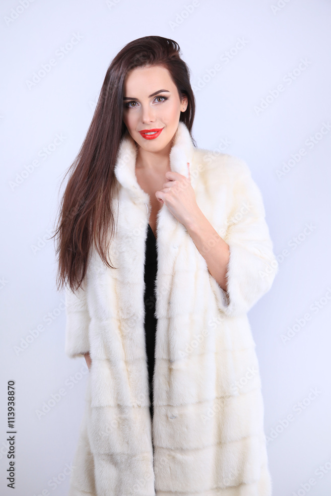 Model in natural fur coat looking at camera Model in natural fur coat looking at camera