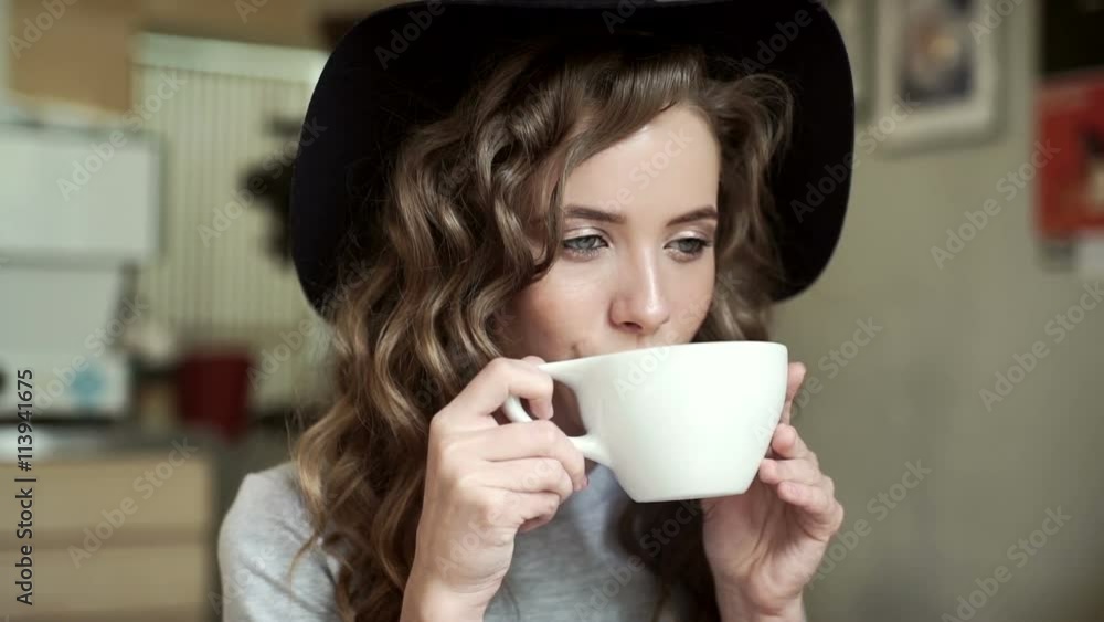 Cute girl in a cafe drinking coffee Cute girl in a cafe drinking coffee