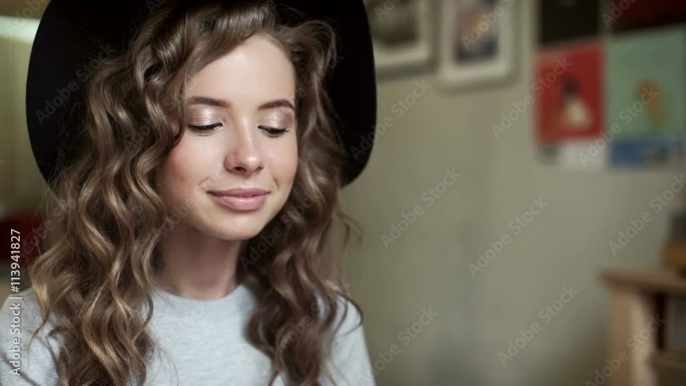 Portrait of happy young funny woman sit in cafe. Cute girl