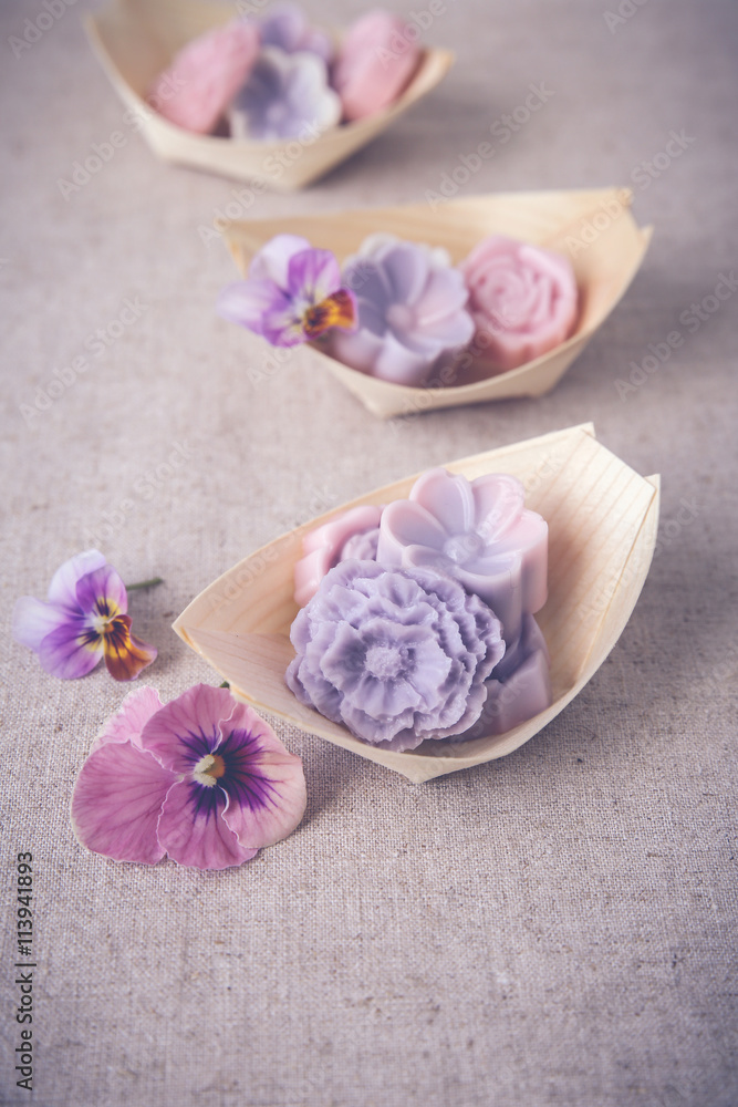 Pastel pink purple flower coconut jelly on bamboo serving boat,toning Pastel pink purple flower coconut jelly on bamboo serving boat,toning