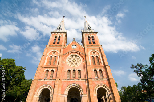 Saigon Notre-Dame Cathedral Basilica (Basilica of Our Lady of The Immaculate Conception) on blue sky background in Ho Chi Minh city, Vietnam. Ho Chi Minh is a popular tourist destination of Asia.
