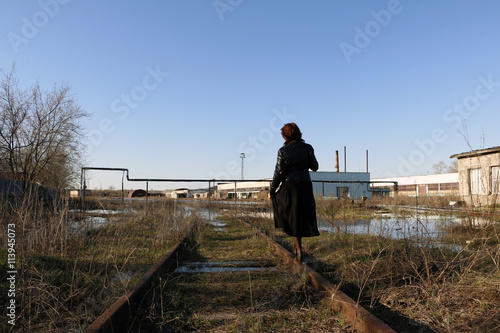 Romantic girl and old railway in water