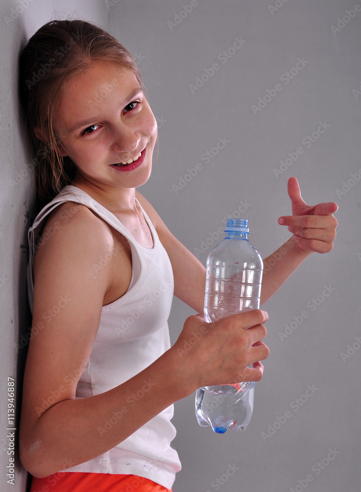 portrait of young sportive teen girl with a bottle of drinking water Stock  Photo