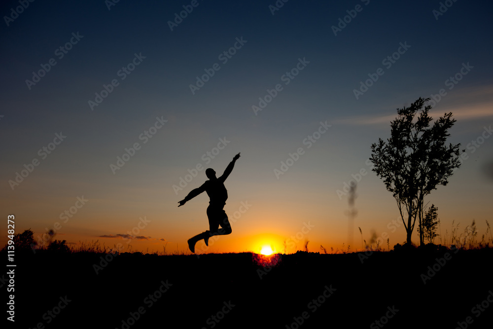 man jumping sunset background. Happy man