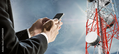 Foto Businessman using mobile phone, with satellite dish telecom network on telecommu