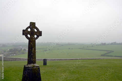 celtic cross on old cemetery and mist background