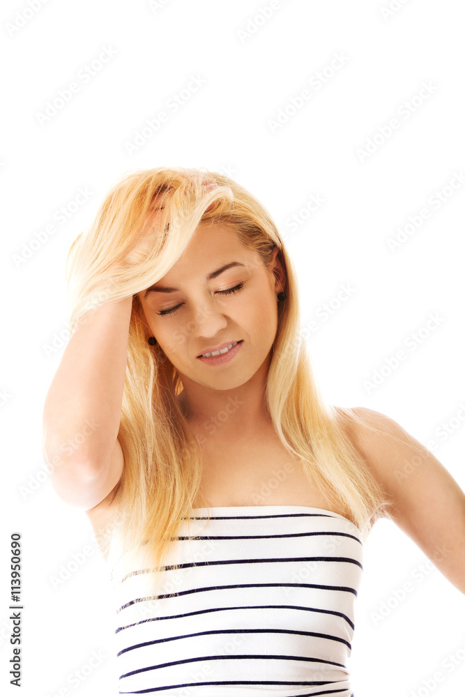 Fototapeta premium Beautiful woman holds a head, suffering from a headache.