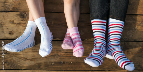 Closeup photo of family feet in colorful socks photo