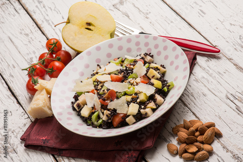 black rice salad with tomatoes apple almond and parmesan cheese photo