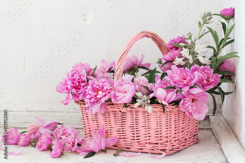 pink peony in basket on old white background