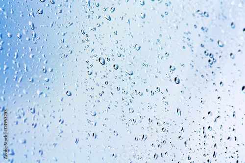 Stream of water in heavy rain. Raindrops on window pane. Blur effect. 