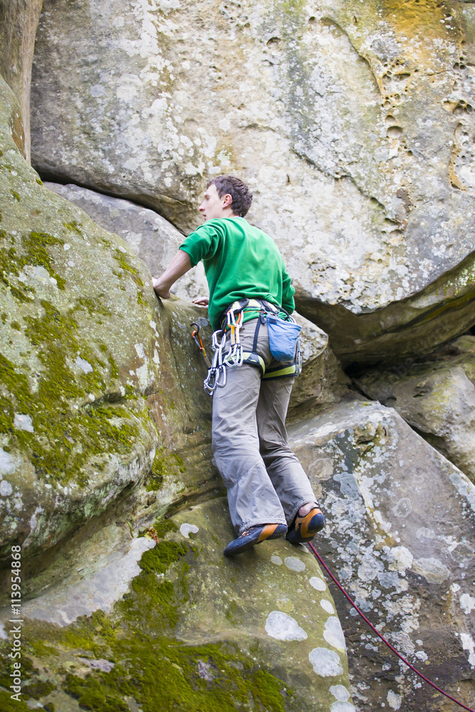 A rock climber climbs up the mountain.