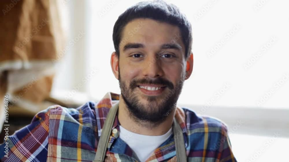 workman in checkered shirt and apron at workshop workman in checkered shirt and apron at workshop