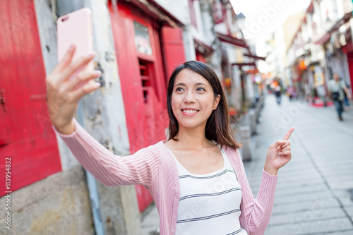 Woman taking self image by cellphone in Macau